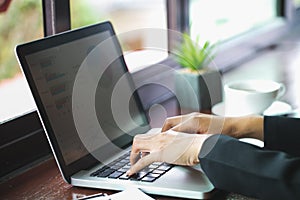 Young Businessman Analyzing Graph On Computer At Workplace