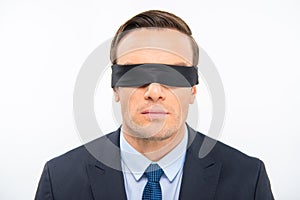 Young businessman in blindfold