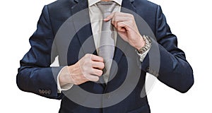 Young businessman in blue suit touching necktie, isolated on white background