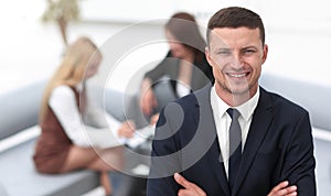 Young businessman on blurred background office.