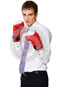 Young businessman with boxing gloves.