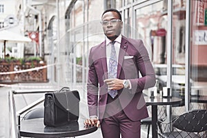 Young businessman with a briefcase near a beautiful office. Business meeting