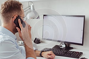 Young businessman brocker on mobile phone in office. Investment, trading stock on bear market photo