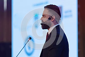 Young businessman at business conference room with public giving presentations. Audience at the conference hall. Entrepreneurship