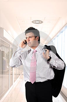 Young businessman is calling on mobile. photo
