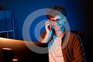 Young businessman calling on phone to customer or coworker. Gusher.