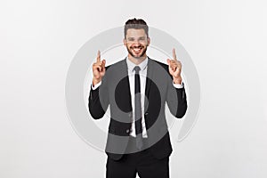 Young businessman celebrating his success over gray background.
