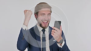Young Businessman Celebrating on Smartphone on White Background