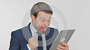 Young Businessman Celebrating Success on Tablet on White Background