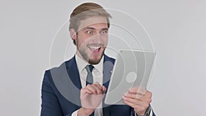 Young Businessman Celebrating Success on Tablet on White Background