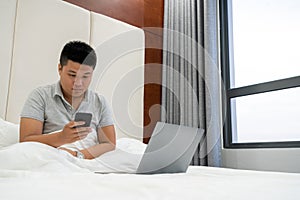 Young man checking emails on smart phone