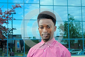 Young businessman in the city portrait in pink shirt office building