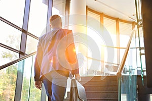 Young businessman climbing stairs in office