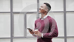 Young businessman communicating on mobile phone chatting outdoors.