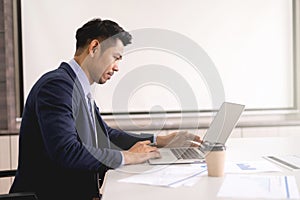 Young businessman concentrate working on laptop with white scree