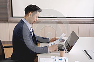 Young businessman concentrate working on laptop with white scree