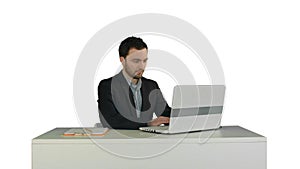 Young businessman concentrating on working with laptop computer on white background isolated