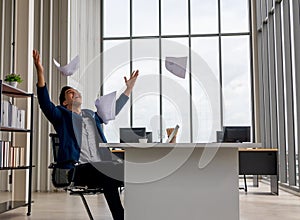 Young Businessman Congratulations and threw the documents Paper flying in the air