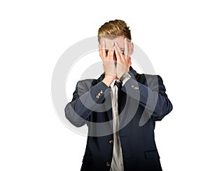 Young businessman in despair covers his face.
