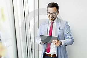 Young businessman with digital tablet in office