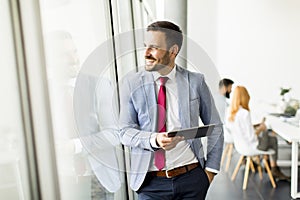 Young businessman with digital tablet in office