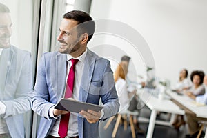 Young businessman with digital tablet in office