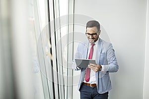 Young businessman with digital tablet in office