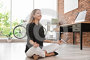 Young businessman doing yoga exercises