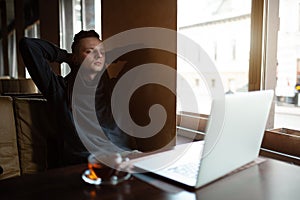 Young Businessman with dreadlock having doing his work in cafe with laptop