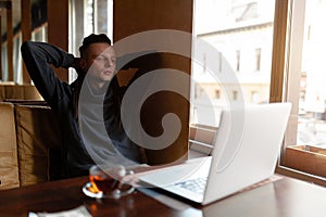 Young Businessman with dreadlock having doing his work in cafe with laptop