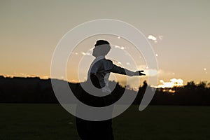 Young businessman enjoying his freedom standing in meadow