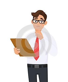 Young businessman in eye glasses holding clipboard and asking silence. Please keep quiet! Person showing or gesturing index finger