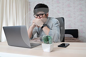 Young businessman in eyewear working at home