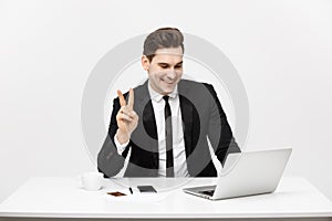 Young businessman facetime with someone and showing two finger or victory finger sign