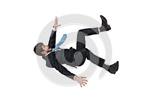 Young businessman falling down in free fall. Isolated on white background