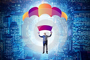 The young businessman falling on parachute in business concept