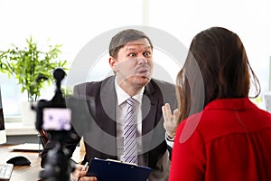 Young businessman feeling mad and expressing anger to woman colleague