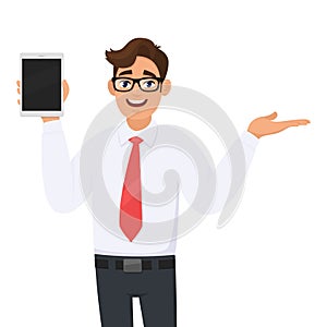 Young businessman in formal wear showing a digital tablet computer & pointing/presenting hand to copy space.