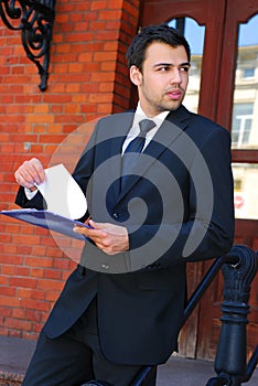 Young businessman in the front of bank