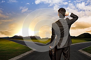 Young businessman in front of a crossroad