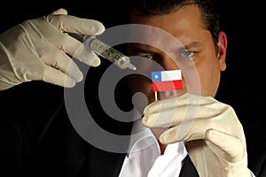 Young businessman gives a financial injection to Chilean flag is