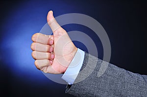 Young businessman giving a thumbs-up sign