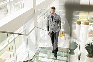 Young businessman going up the stairs