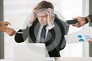 Young businessman grabbing his head