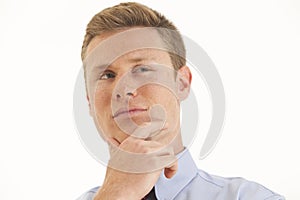 Young businessman with hand on chin