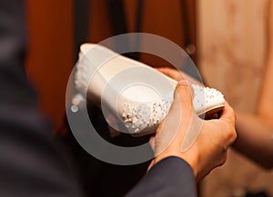 Young businessman with hands in the women's shoes