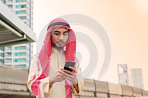 Young businessman handsom arabian handholding smart phone