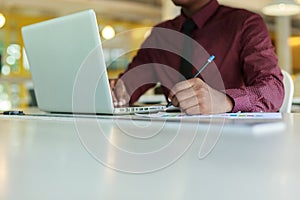 Young businessman handsome African American black skin working on laptop at office. businessperson in workplace