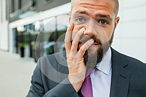 Young businessman having headache because of problems at work.