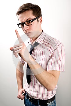 Young businessman having idea and pointing with finger